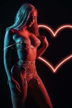 female stripper squeezing her breasts together in super tight lingerie