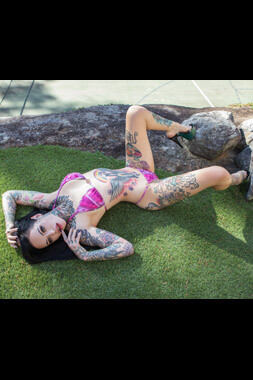 hot topless waitress in colourful bikini lying seductively on a bellevue hill lawn